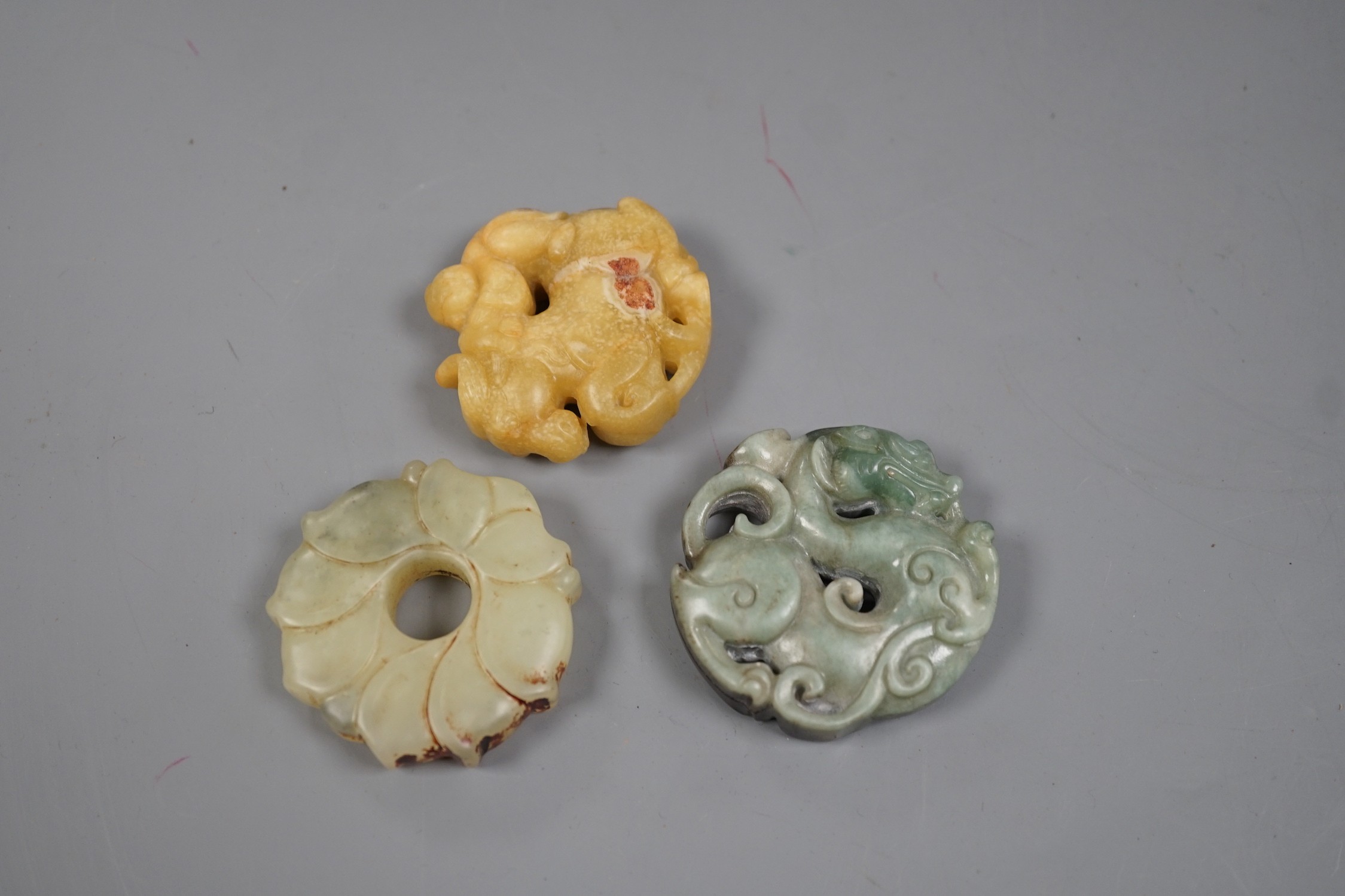 Three Chinese russet jade or hardstone bi discs